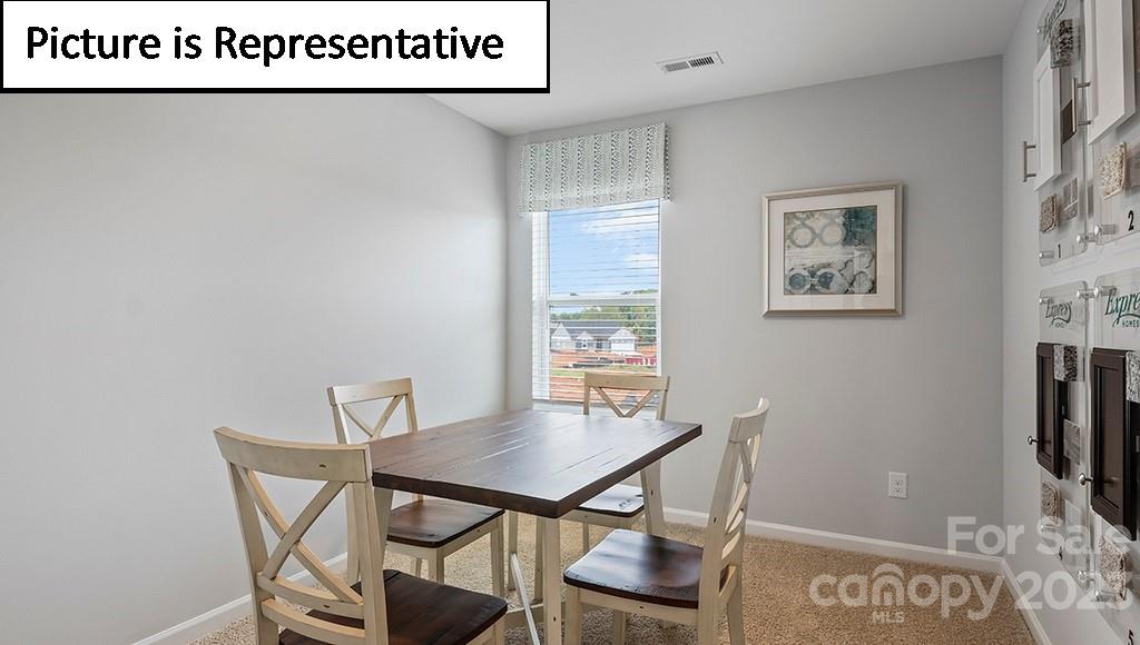 9027 Lowfalls Lane Charlotte, NC 28216 - Photo 23 of 27 a view of a room with furniture wooden floor and window
