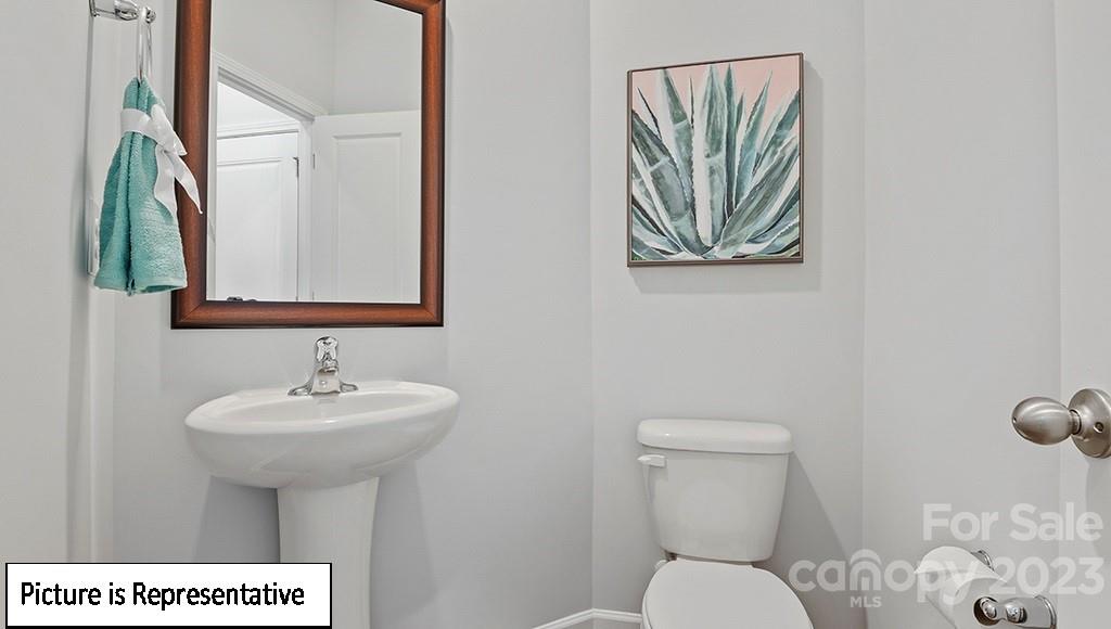 9027 Lowfalls Lane Charlotte, NC 28216 - Photo 4 of 27 a bathroom with a toilet sink and mirror