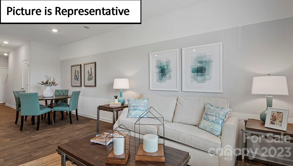 9027 Lowfalls Lane Charlotte, NC 28216 - Photo 7 of 27 a living room with furniture and wooden floor