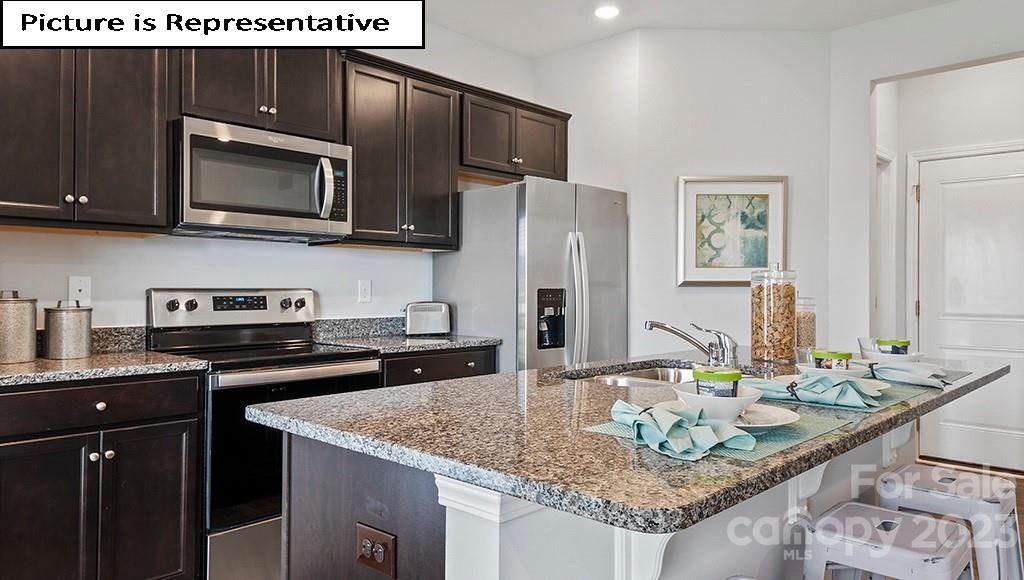 9027 Lowfalls Lane Charlotte, NC 28216 - Photo 9 of 27 a kitchen with granite countertop a sink and stainless steel appliances