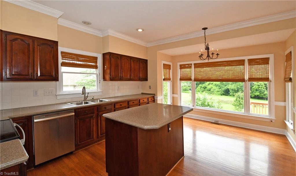 8040 Glengarriff Road Clemmons, NC 27012 - Photo 4 of 26 Kitchen w/ ss appliances, corian countertops, & large breakfast area