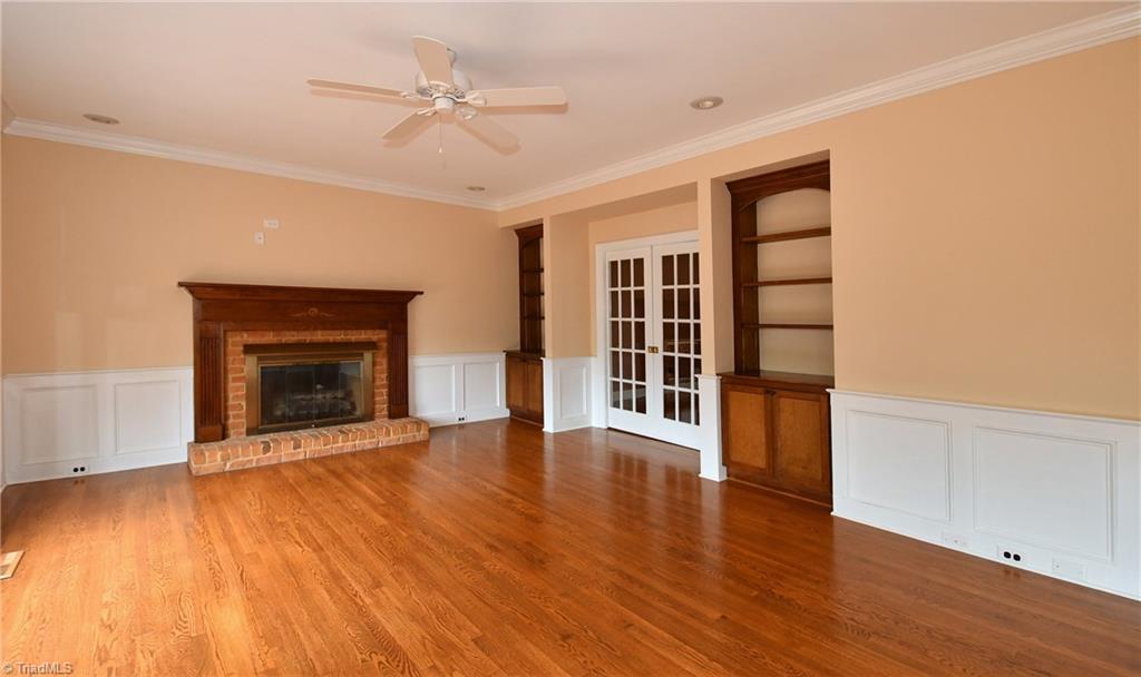 8040 Glengarriff Road Clemmons, NC 27012 - Photo 8 of 26 Den w/ built-in shelves/cabinets and pocket door to LR