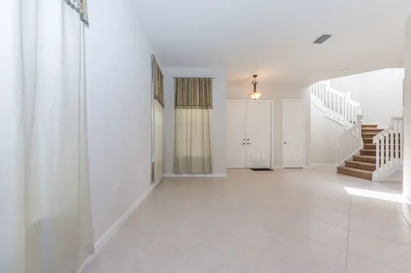 a view of a livingroom with entryway and stairs