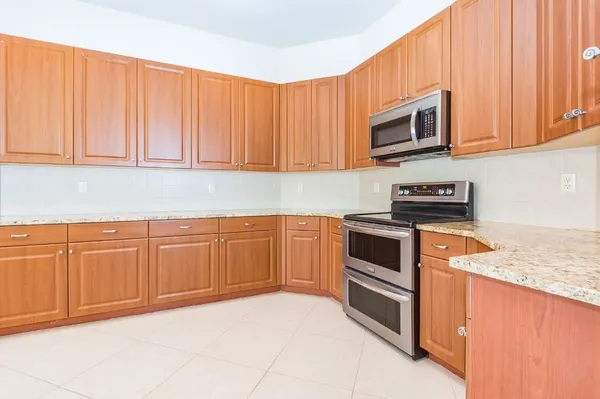 a kitchen with kitchen island wooden cabinets and counter space
