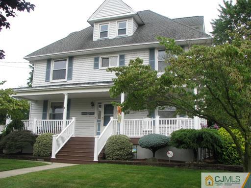 121 New Market Road Dunellen, NJ 08812 - Photo 1 of 23 a front view of a house with garden