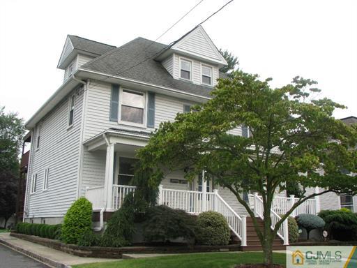 121 New Market Road Dunellen, NJ 08812 - Photo 2 of 23 a front view of a house with a yard