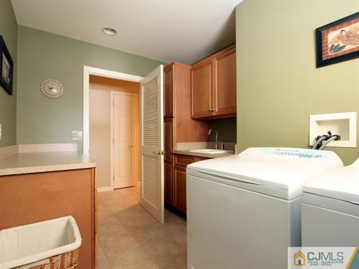 121 New Market Road Dunellen, NJ 08812 - Photo 11 of 23 a utility room with dryer and washer