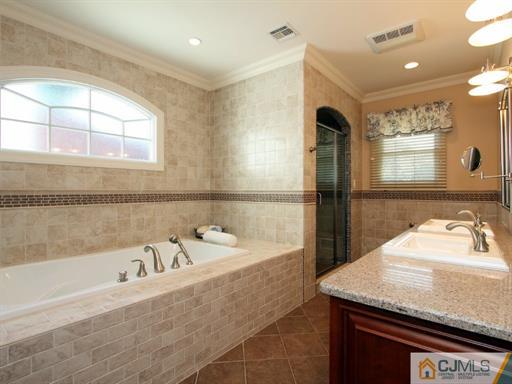 121 New Market Road Dunellen, NJ 08812 - Photo 13 of 23 a spacious bathroom with a granite countertop tub sink and mirror