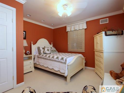 121 New Market Road Dunellen, NJ 08812 - Photo 15 of 23 a bedroom with a bed and a dresser