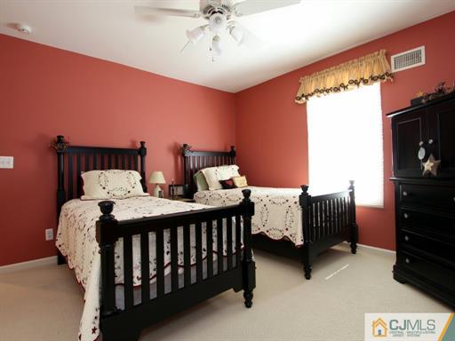 121 New Market Road Dunellen, NJ 08812 - Photo 16 of 23 a bedroom with two beds and a chandelier