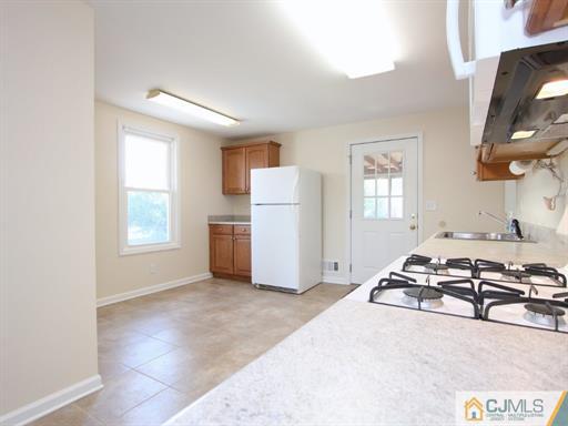 121 New Market Road Dunellen, NJ 08812 - Photo 18 of 23 a living room with furniture a window and a fireplace