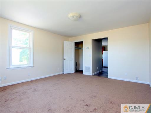 121 New Market Road Dunellen, NJ 08812 - Photo 20 of 23 a view of an empty room with a window