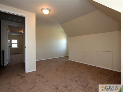 121 New Market Road Dunellen, NJ 08812 - Photo 22 of 23 an empty room with closet and mirror
