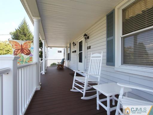 121 New Market Road Dunellen, NJ 08812 - Photo 4 of 23 a view of a porch with furniture and a gate