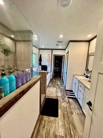 a bathroom with a bathtub and next to a window