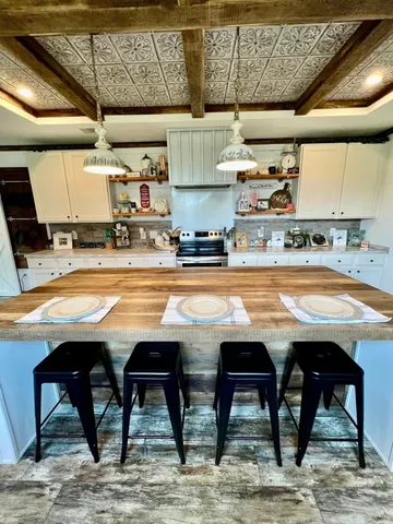 a view of a kitchen with a stove and a microwave