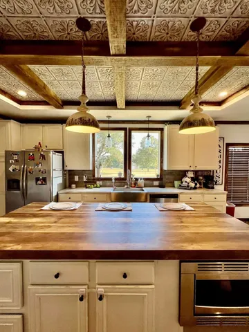 a bedroom with a bed and a dresser next to a window