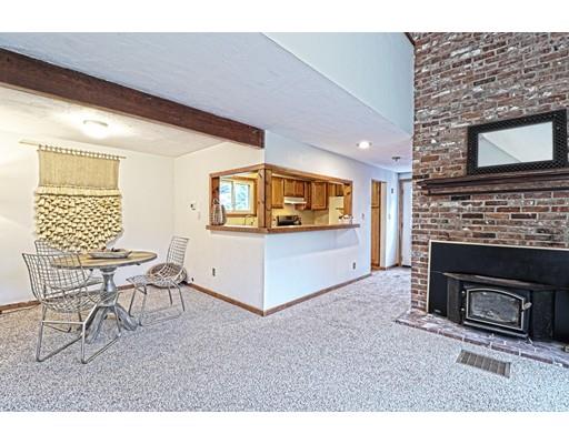 2 Clover Hill Road Acton, MA 01720 - Photo 2 of 11 a living room with furniture a fireplace and a flat screen tv