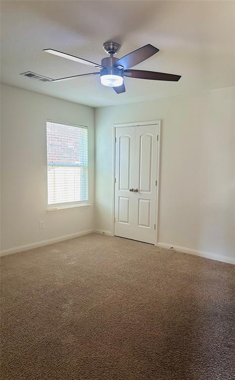 1314 Tamarack Drive Princeton, TX 75407 - Photo 11 of 12 an empty room with windows and fan