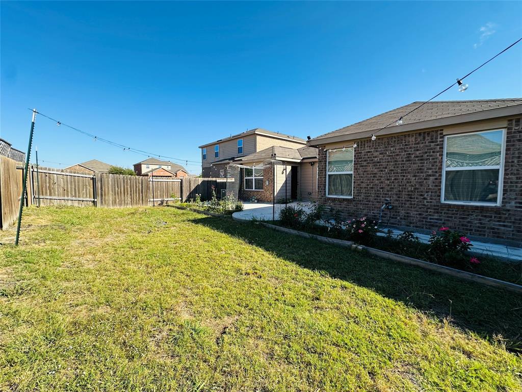 1314 Tamarack Drive Princeton, TX 75407 - Photo 2 of 12 a front view of a house with a yard
