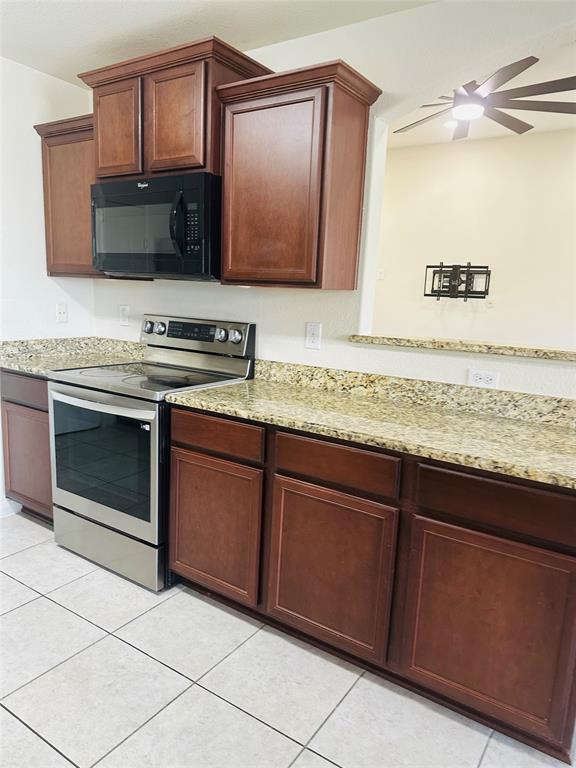 1314 Tamarack Drive Princeton, TX 75407 - Photo 3 of 12 a kitchen with granite countertop stainless steel appliances a stove a sink and a microwave