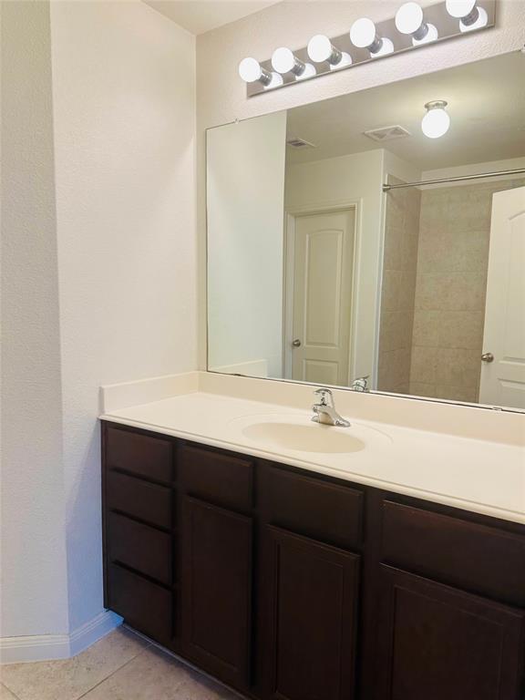 1314 Tamarack Drive Princeton, TX 75407 - Photo 9 of 12 a bathroom with a sink and a mirror