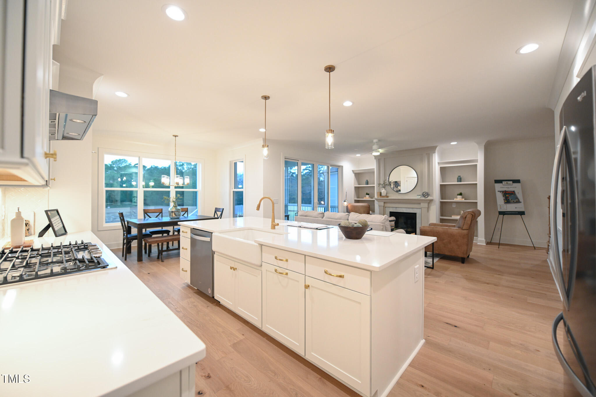 143 Sallyport Court Raleigh, NC 27603 - Photo 13 of 46 a open kitchen with a sink a stove and a wooden floors