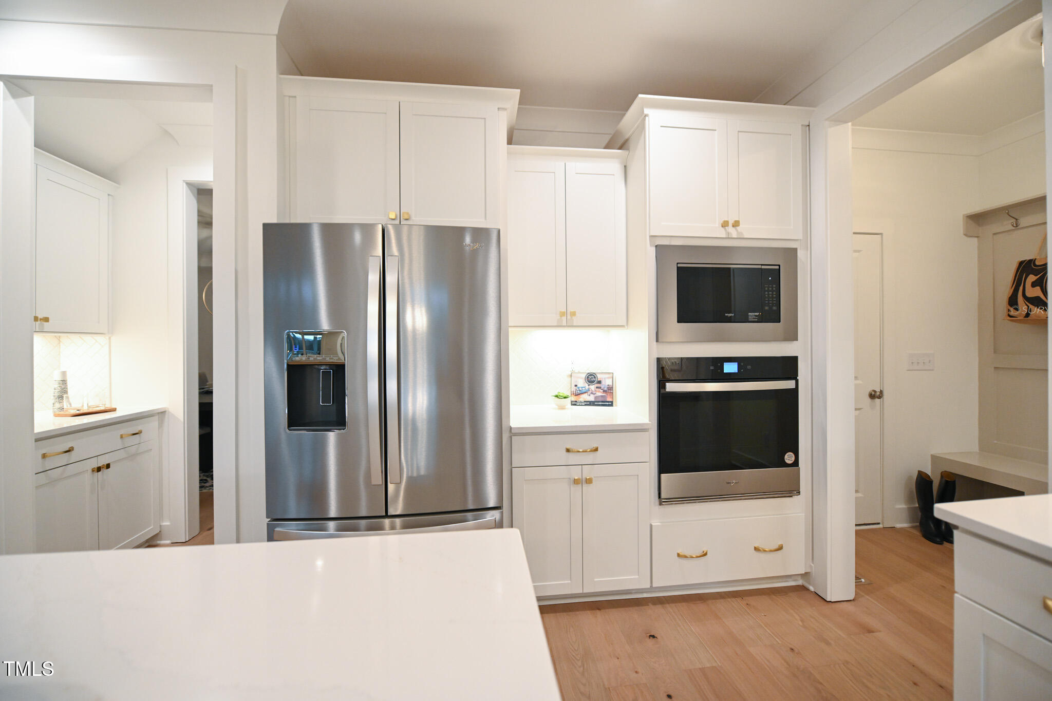 143 Sallyport Court Raleigh, NC 27603 - Photo 16 of 46 a kitchen with stainless steel appliances a refrigerator a stove and white cabinets