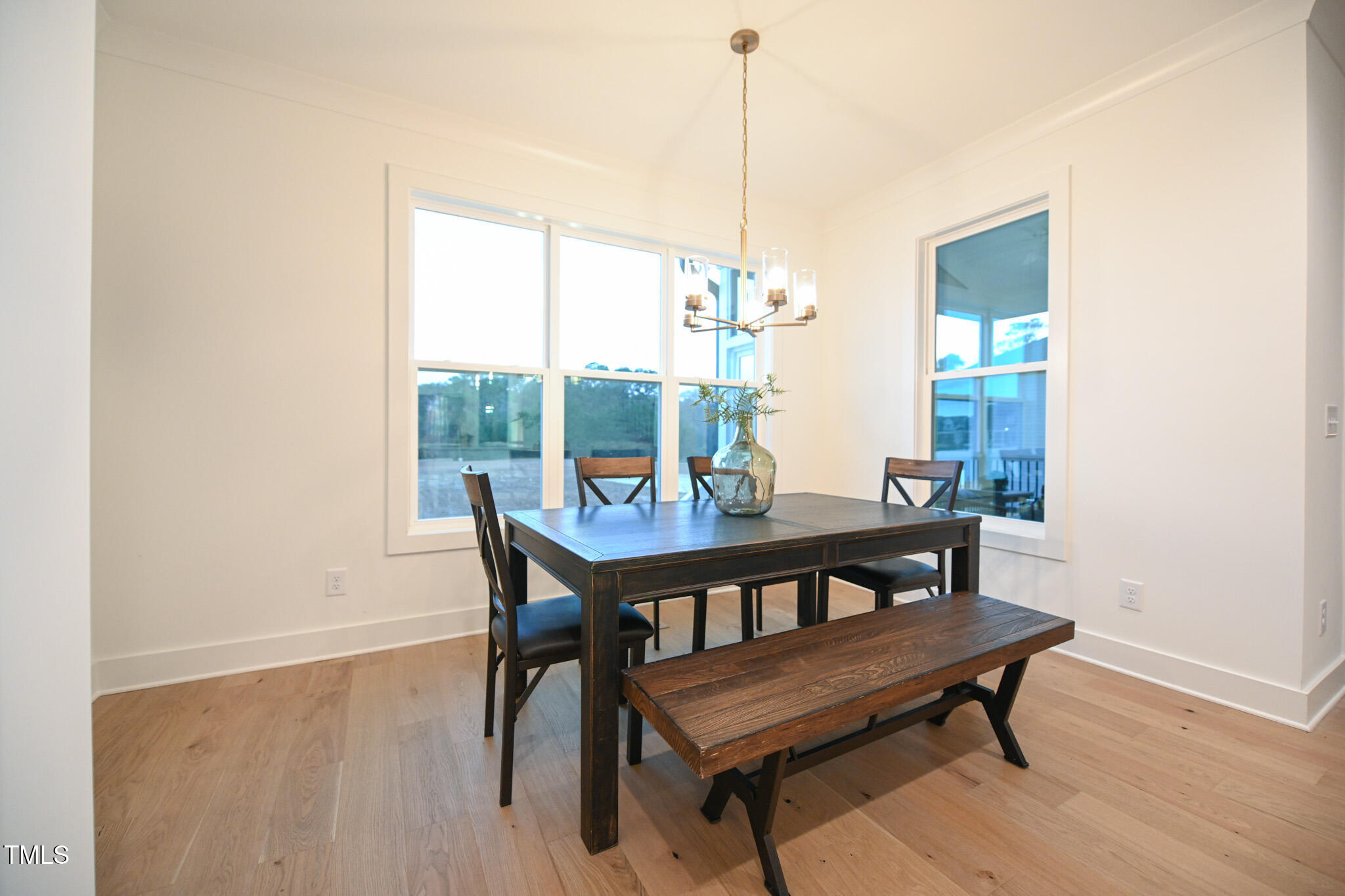 143 Sallyport Court Raleigh, NC 27603 - Photo 19 of 46 a view of a dining room with furniture window and wooden floor