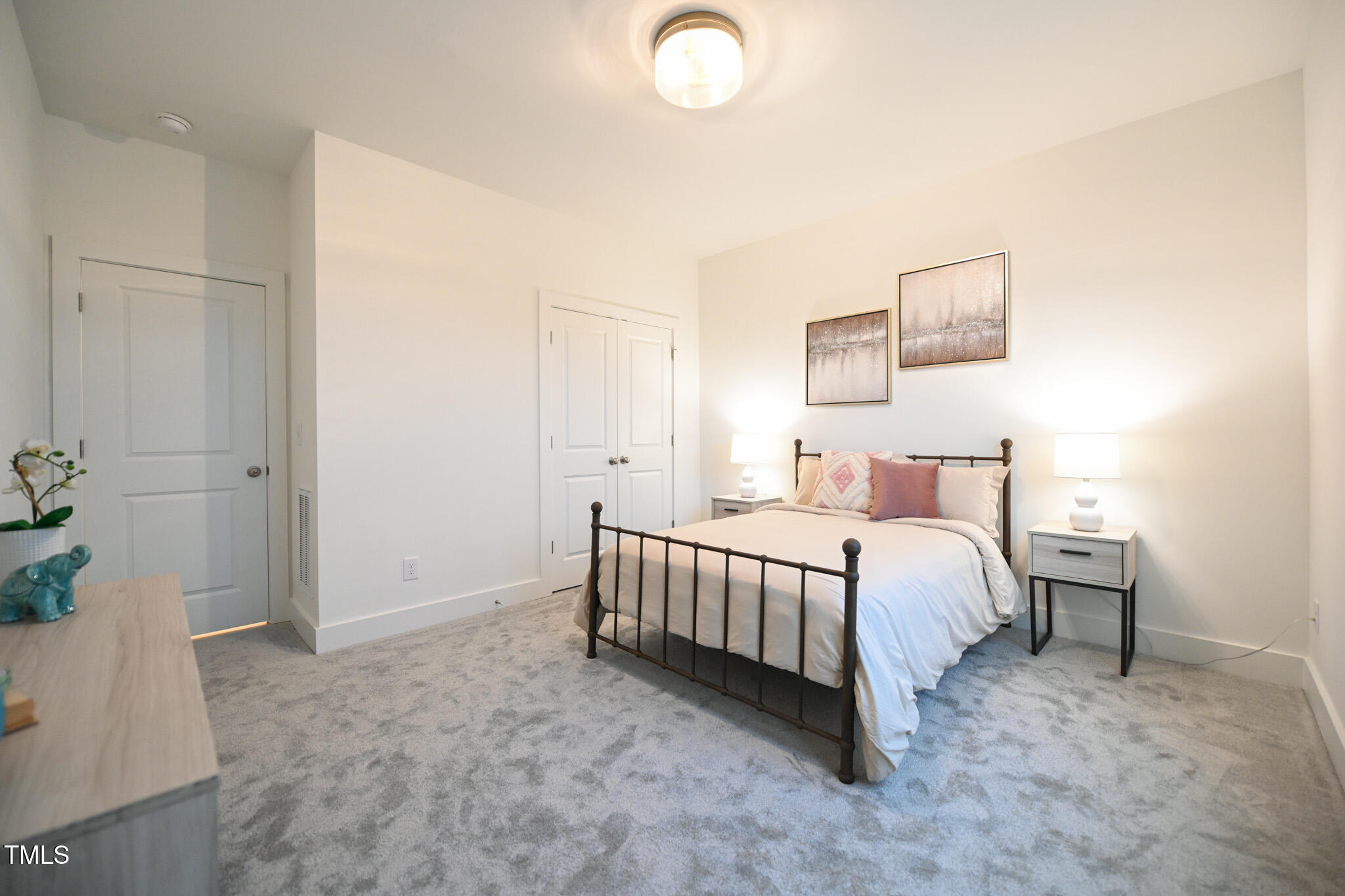 143 Sallyport Court Raleigh, NC 27603 - Photo 28 of 46 a spacious bedroom with a bed and a cabinets