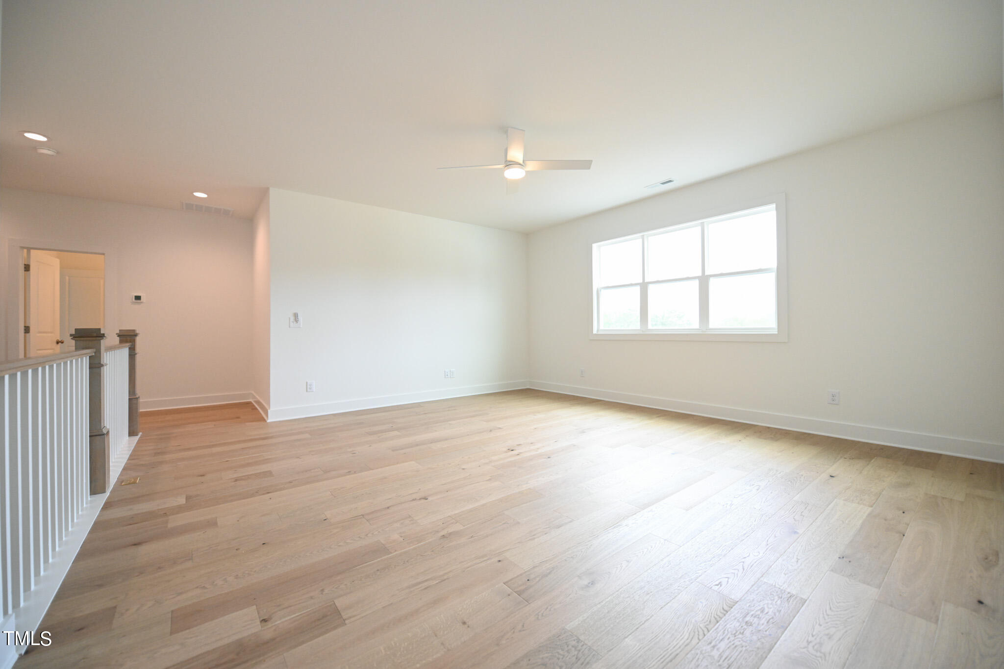 143 Sallyport Court Raleigh, NC 27603 - Photo 32 of 46 an empty room with wooden floor and windows