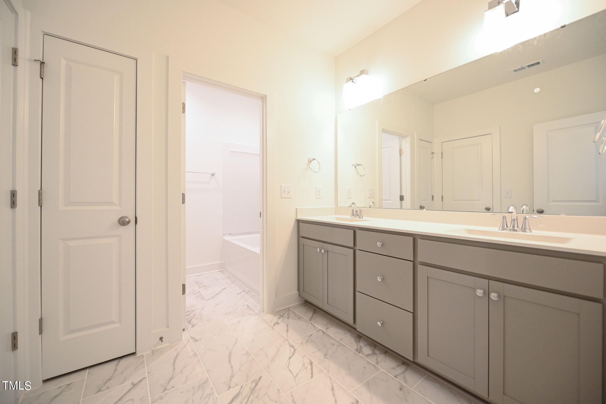 143 Sallyport Court Raleigh, NC 27603 - Photo 39 of 46 a spacious bathroom with a double vanity sink mirror and shower