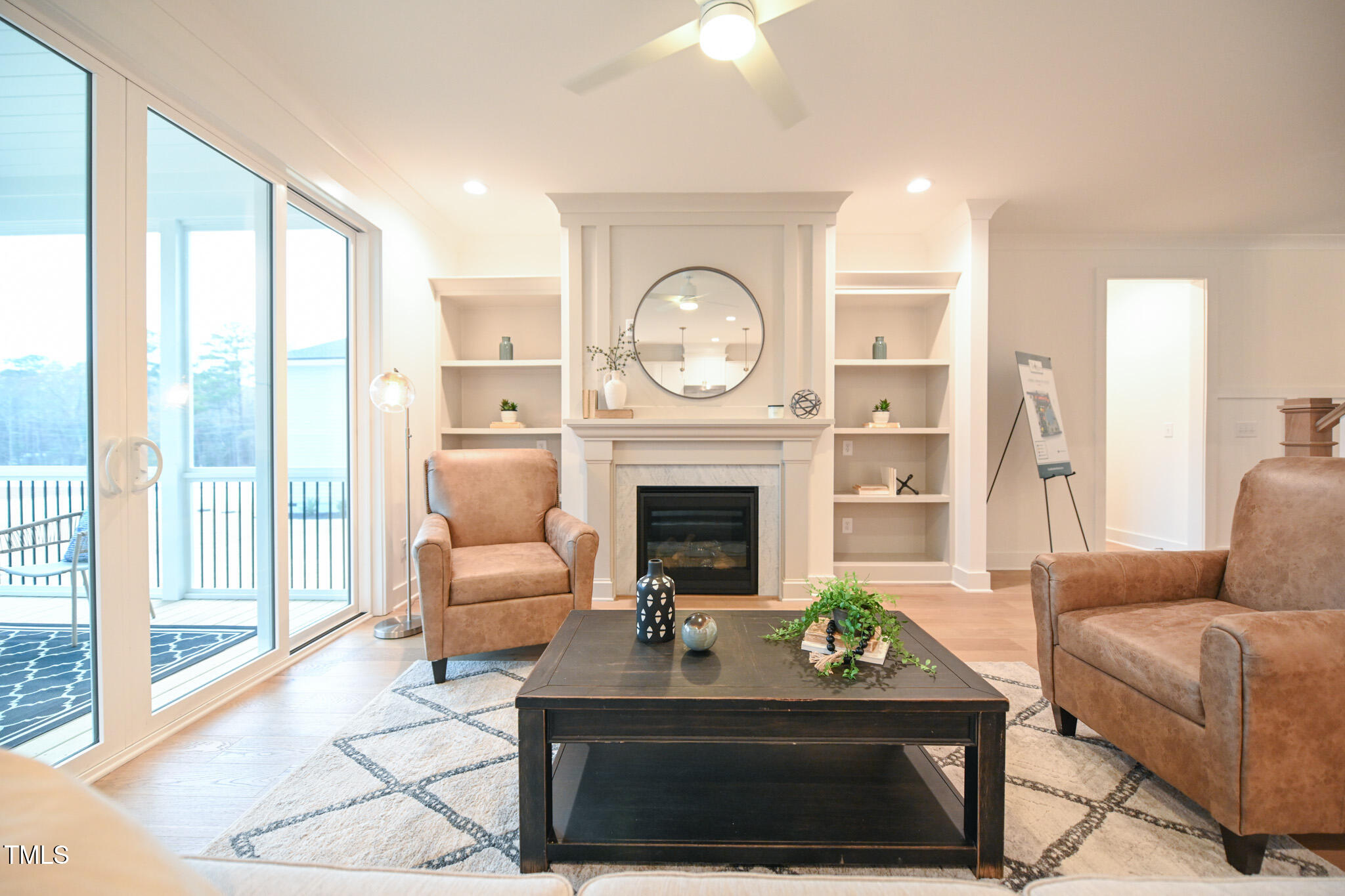 143 Sallyport Court Raleigh, NC 27603 - Photo 10 of 46 a living room with furniture a large window and a fireplace