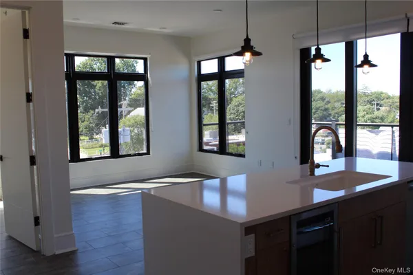 a view of kitchen with windows and refrigerator
