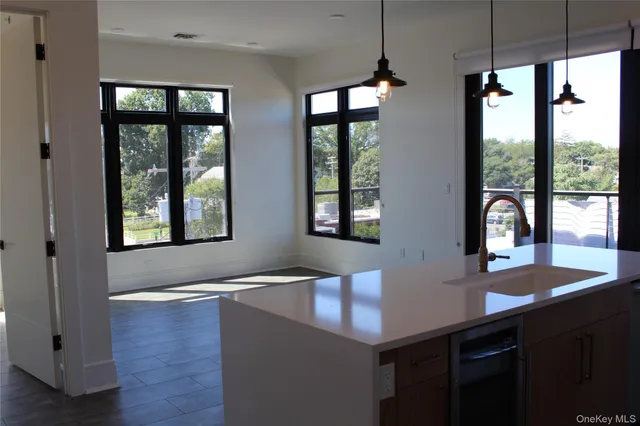 a view of kitchen with windows and refrigerator