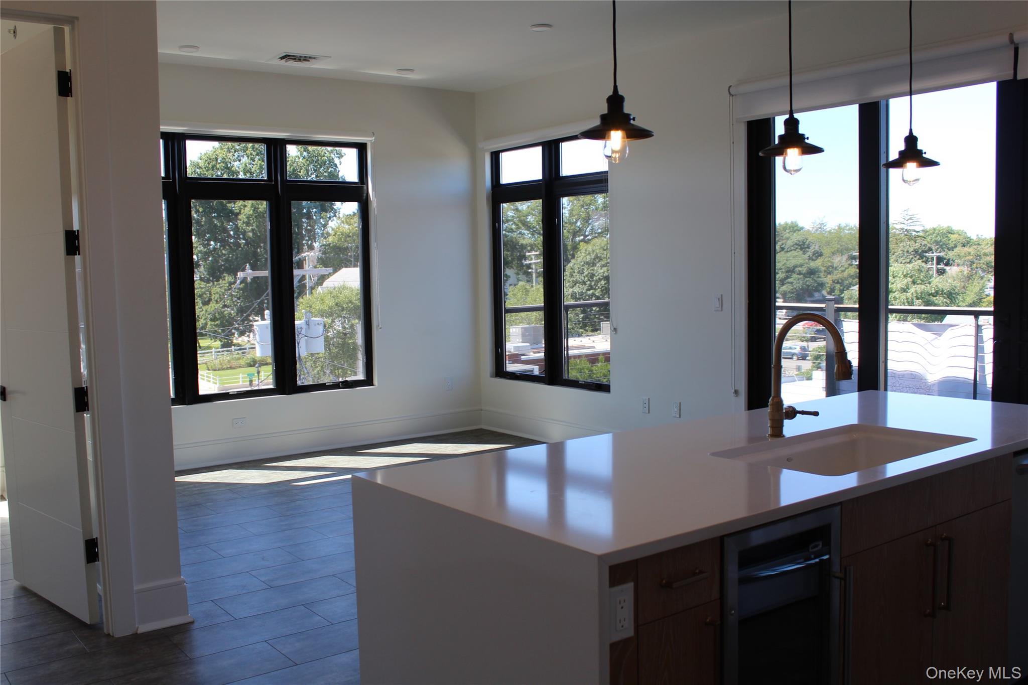 331 East Main Street, Unit 404 Riverhead, NY 11901 - Photo 2 of 5 a view of kitchen with windows and refrigerator