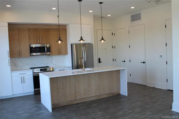 a kitchen with stainless steel appliances a refrigerator sink and stove