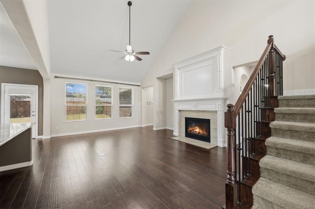 12809 Spring Hill Drive Frisco, TX 75035 - Photo 16 of 37 a view of an empty room with wooden floor fireplace and a window