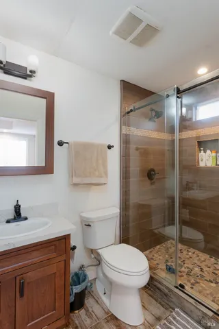 a bathroom with a sink toilet and shower