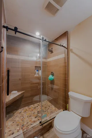 a bathroom with a shower and a toilet