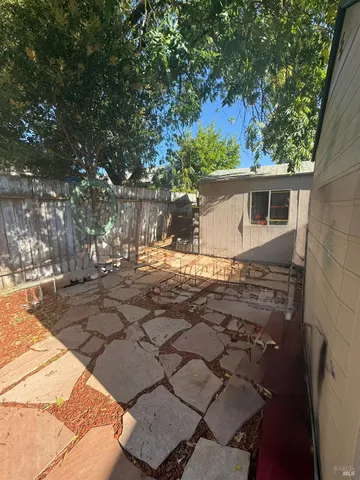 a view of a house with a backyard