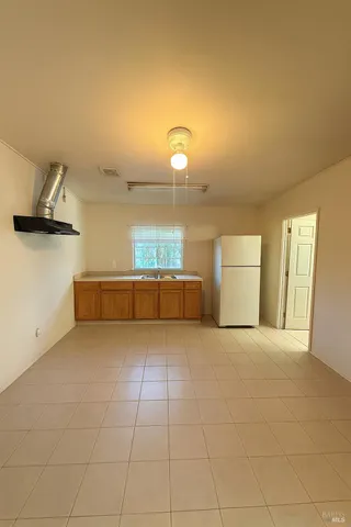 a kitchen with a sink a stove and a refrigerator