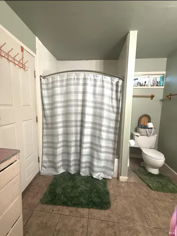 a bedroom with a bed and a night stand