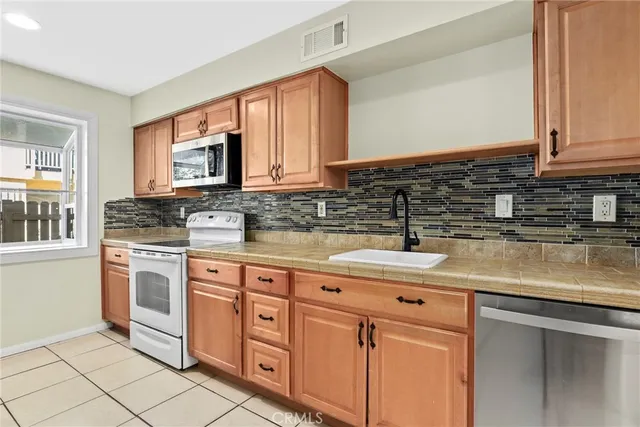 a kitchen with a refrigerator and a stove