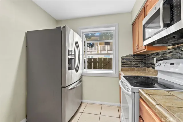a kitchen with granite countertop a sink and cabinets