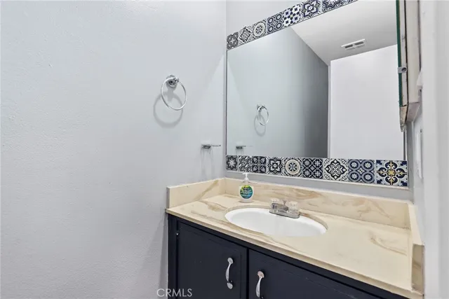 a bedroom with a large bed and a potted plant