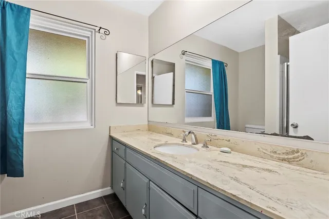 an empty room with wooden floor and window