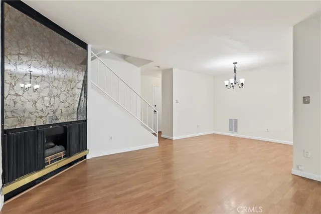 an empty room with wooden floor and bathroom