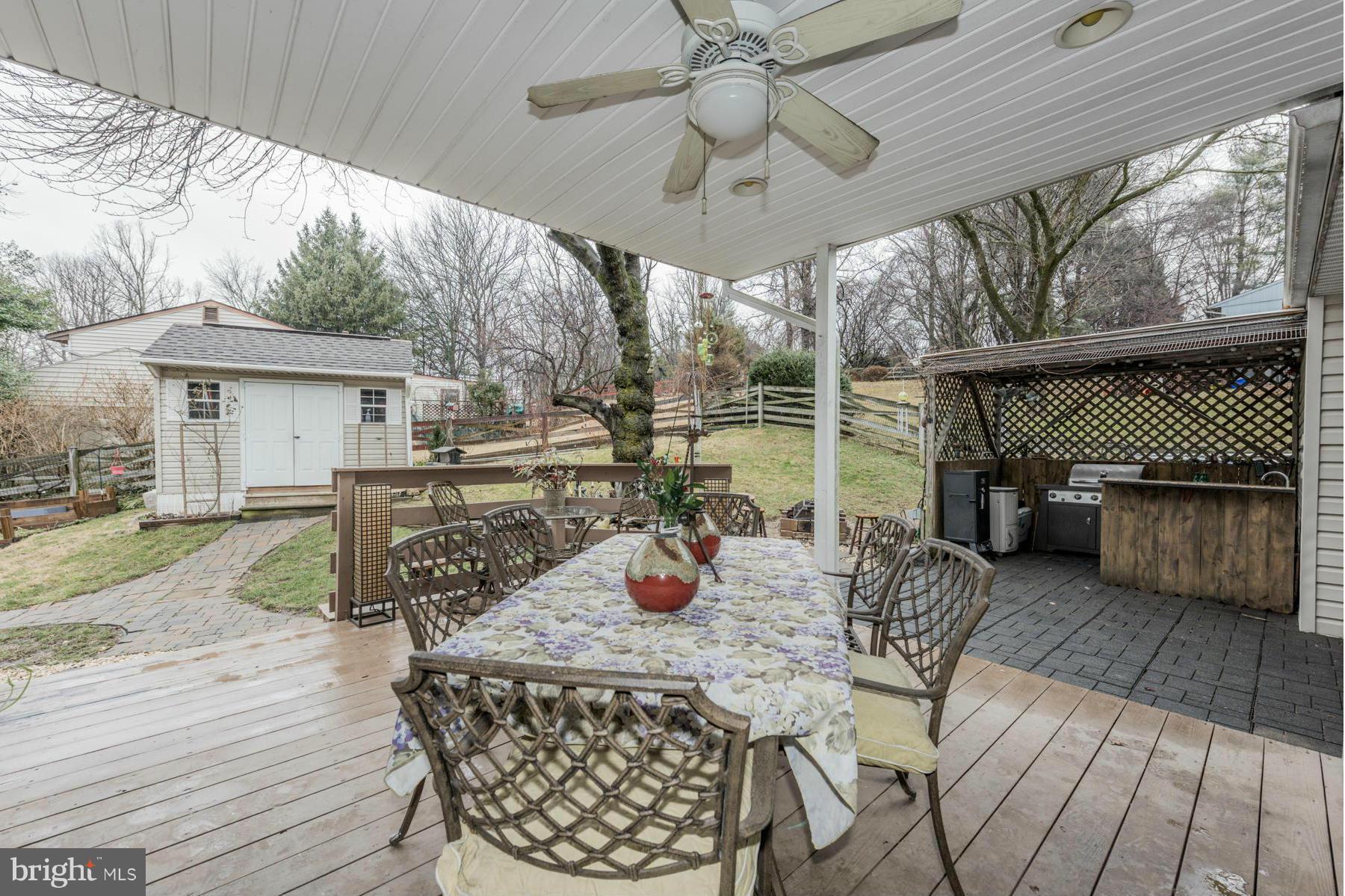 6166 Stevens Forest Road Columbia, MD 21045 - Photo 4 of 28 a view of a patio with a table chairs and a backyard