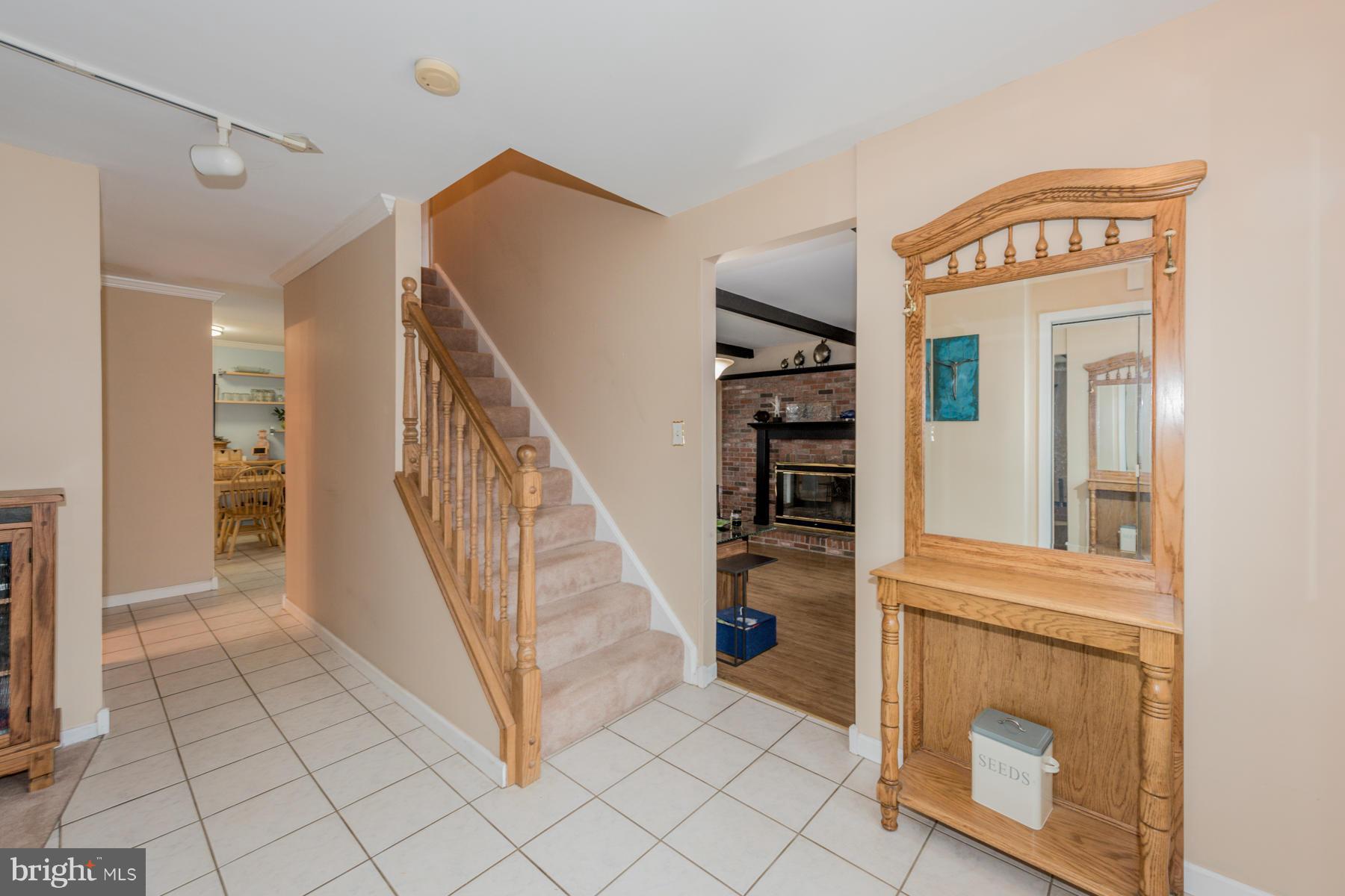 6166 Stevens Forest Road Columbia, MD 21045 - Photo 5 of 28 a view of a hallway to a bedroom with wooden floor and staircase